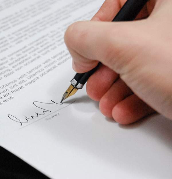 Hand signing a document